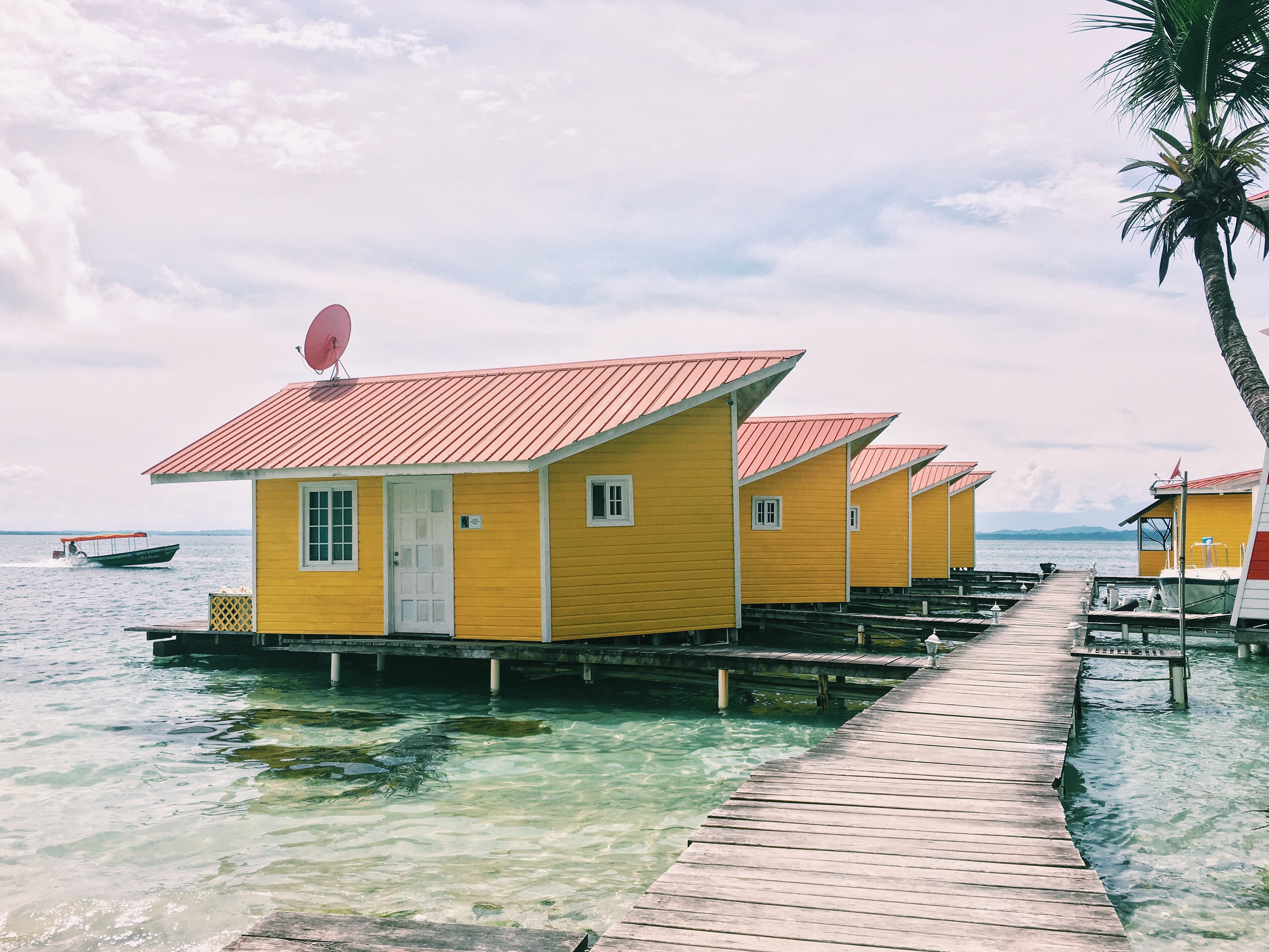 Yellow over-water cabins on a boardwalk in Bocas del Toro, Panama
