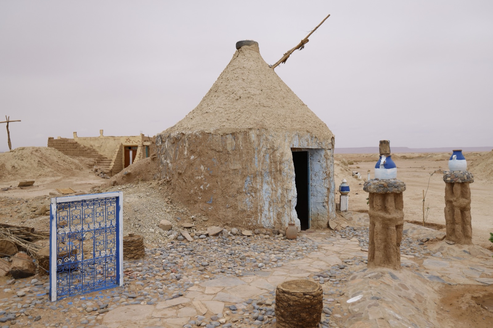 A traditional earthen adobe structure in an arid landscape