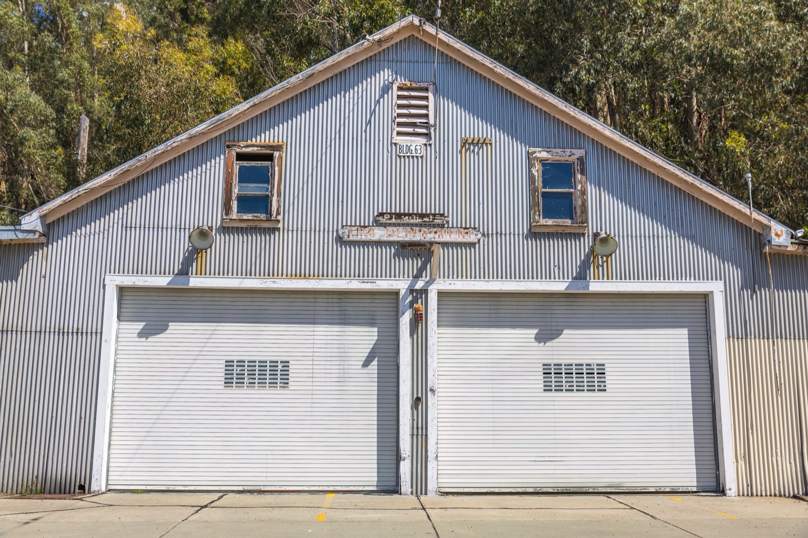 A metal barndominium with garage doors and living quarters