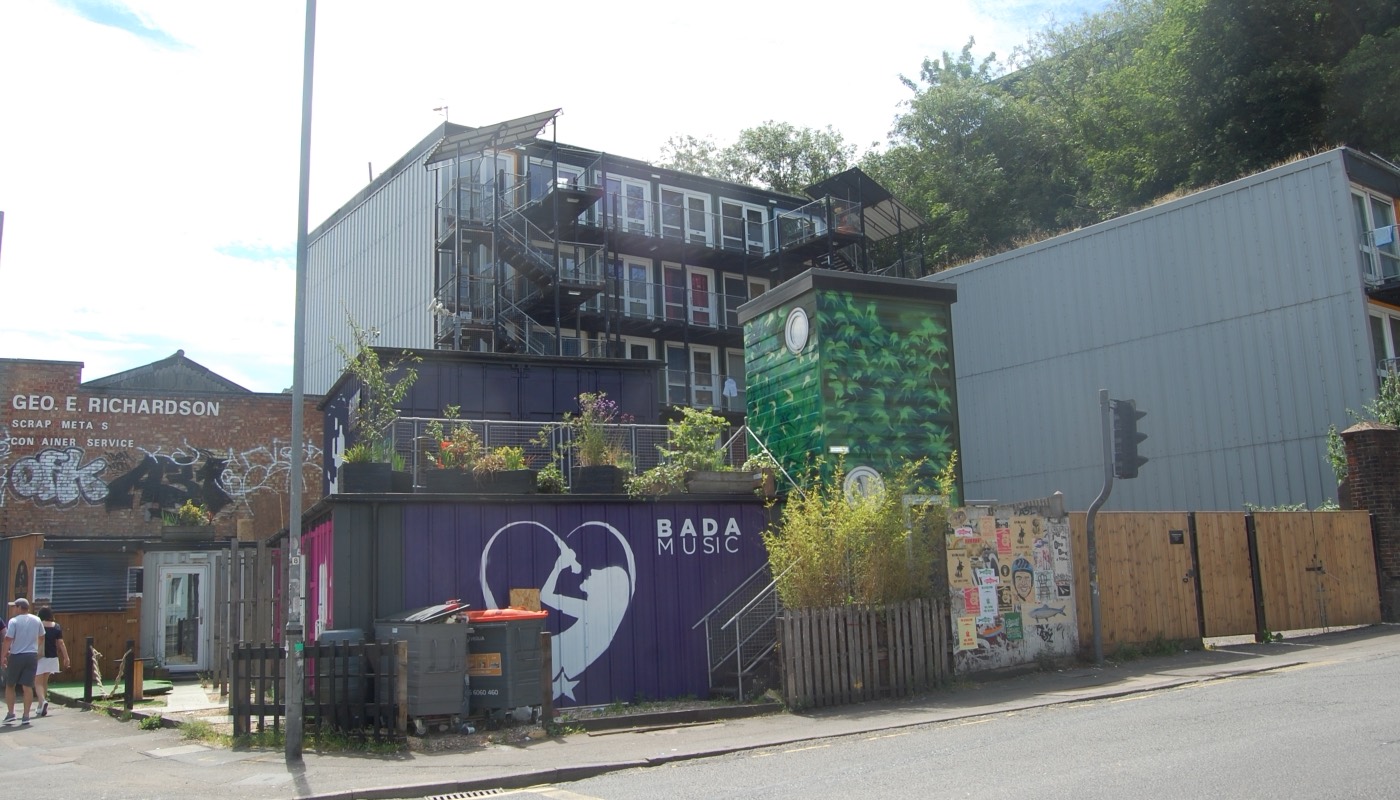 The same Brighton container housing site in 2019, now with planted terraces, murals and additional units