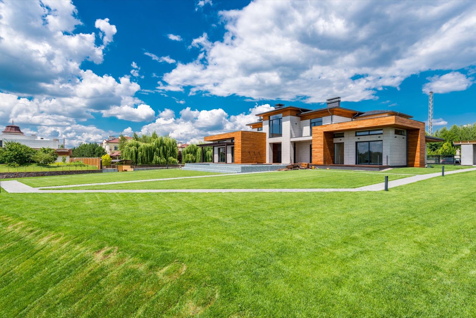 A modern earth-toned house with landscaped lawn