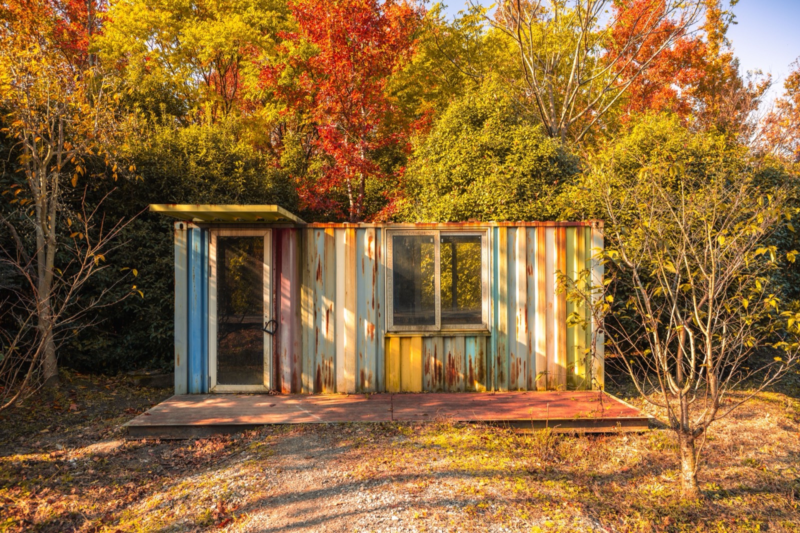 A shipping container converted into a small home with windows