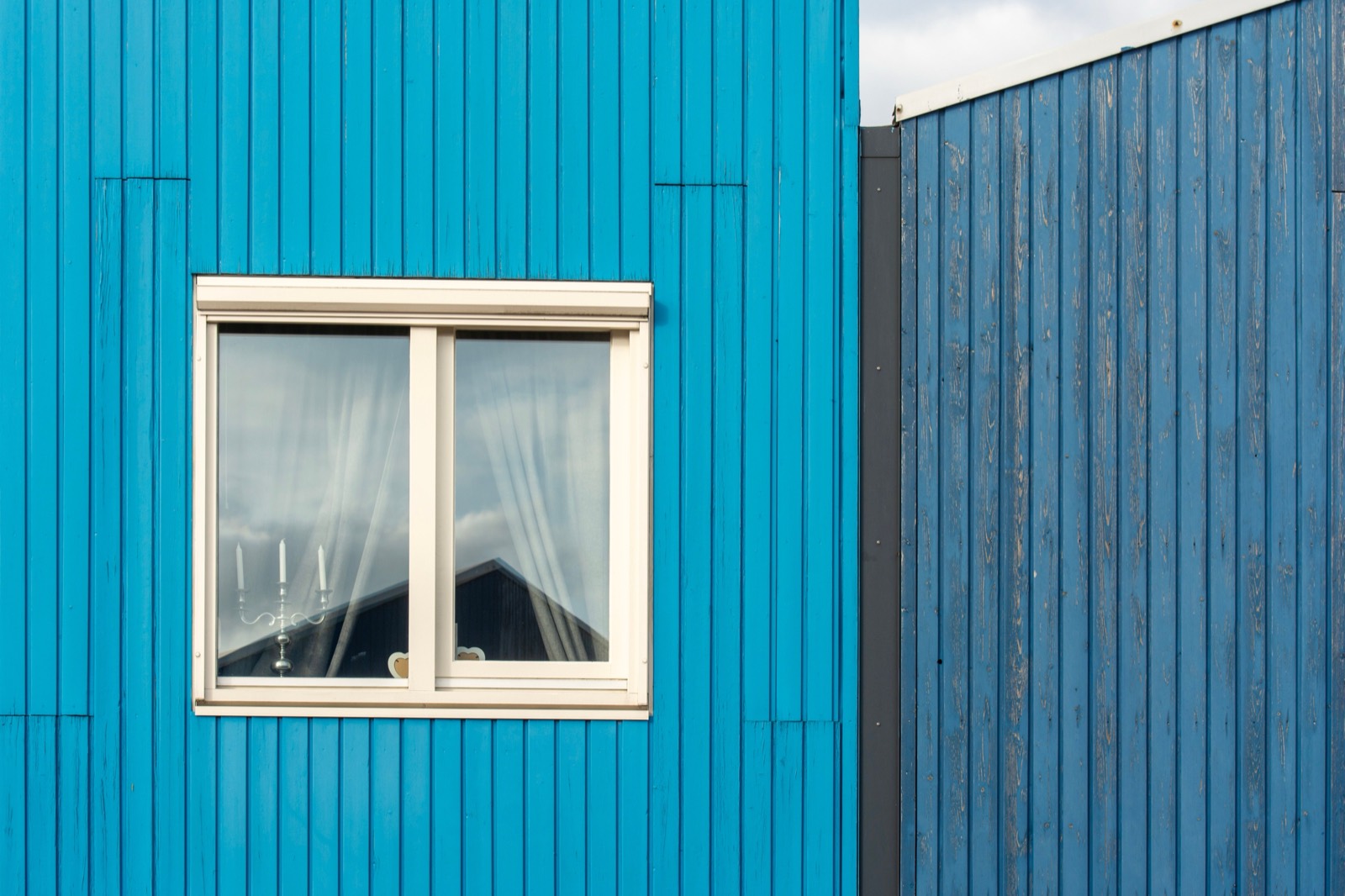 Panel-clad building wall with a window
