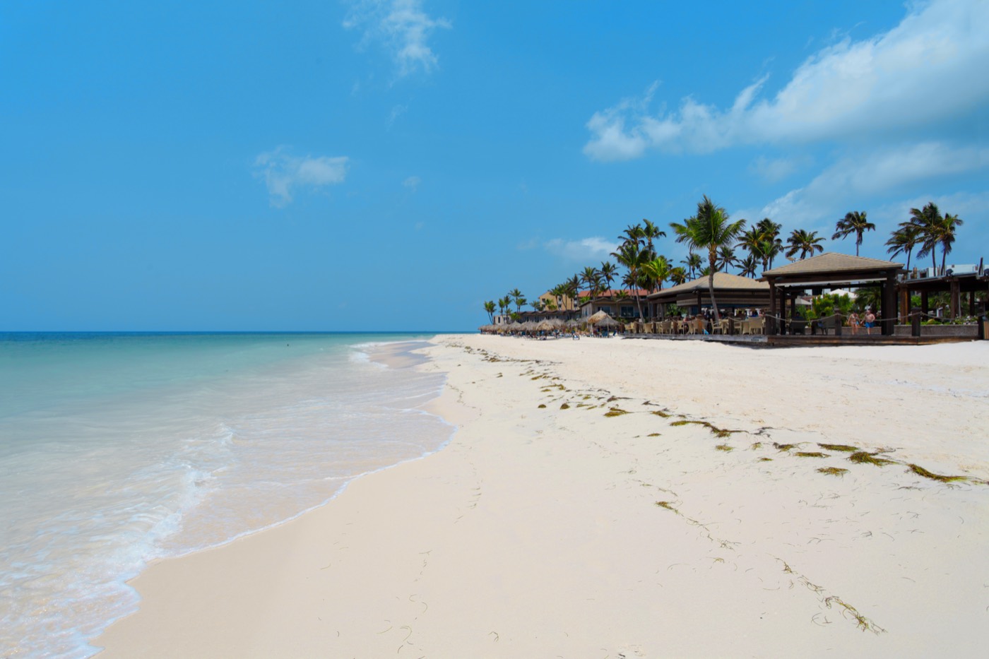 White-sand beach with palapas on Aruba's west coast