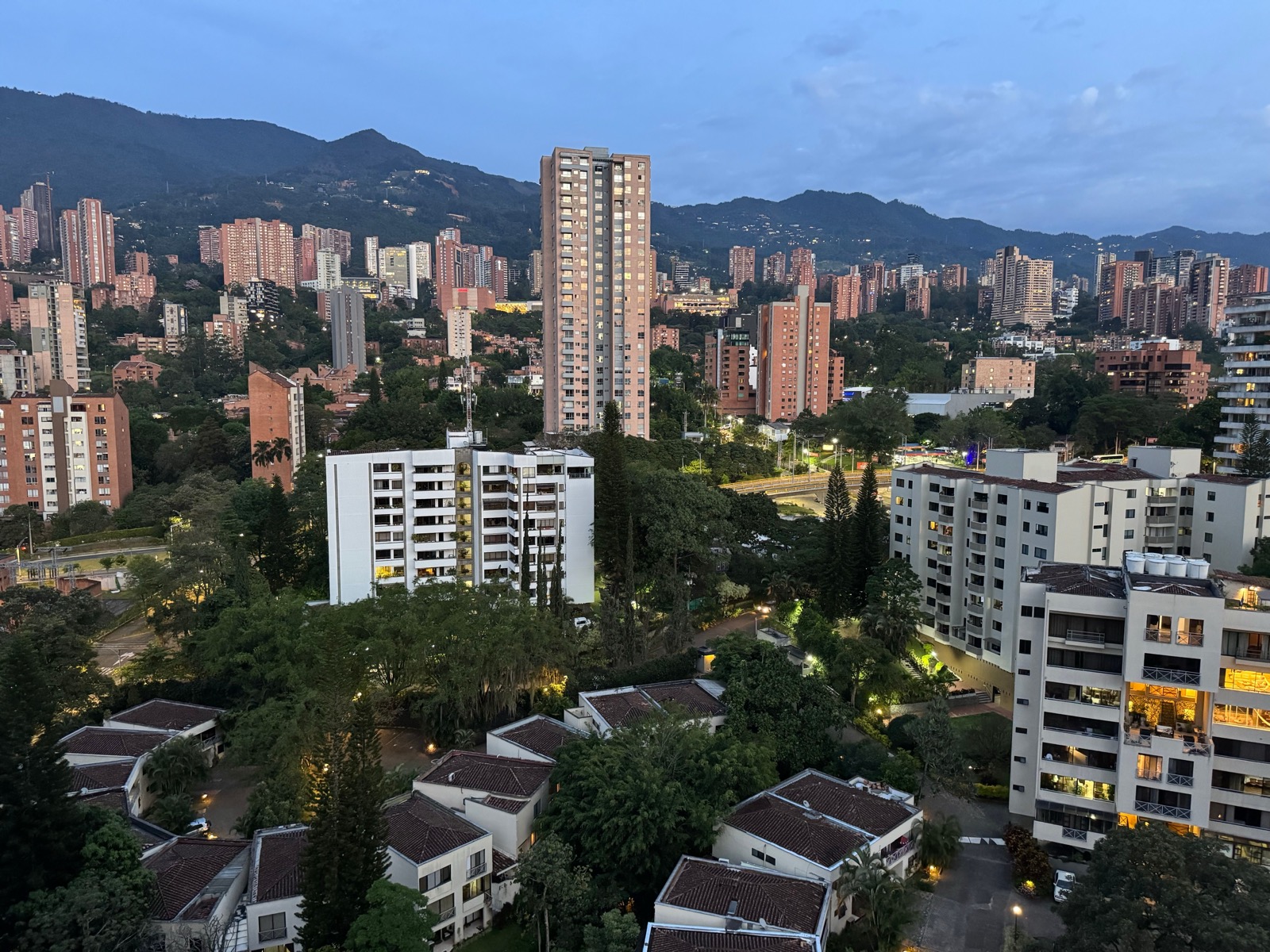 Modern apartment towers on a green hillside in El Poblado, Medellín