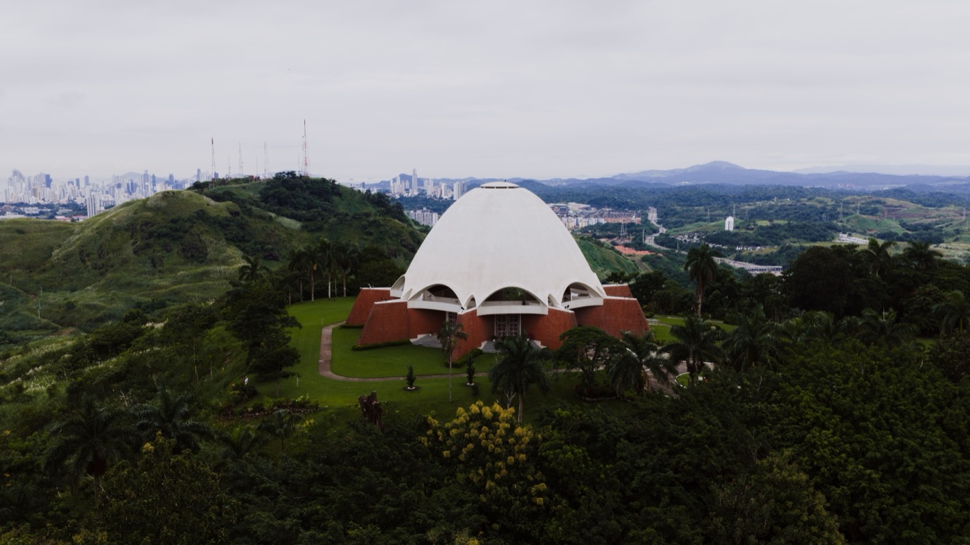 Green Panama highlands with the capital's skyline in the distance, foreign buyers can own titled land across the country